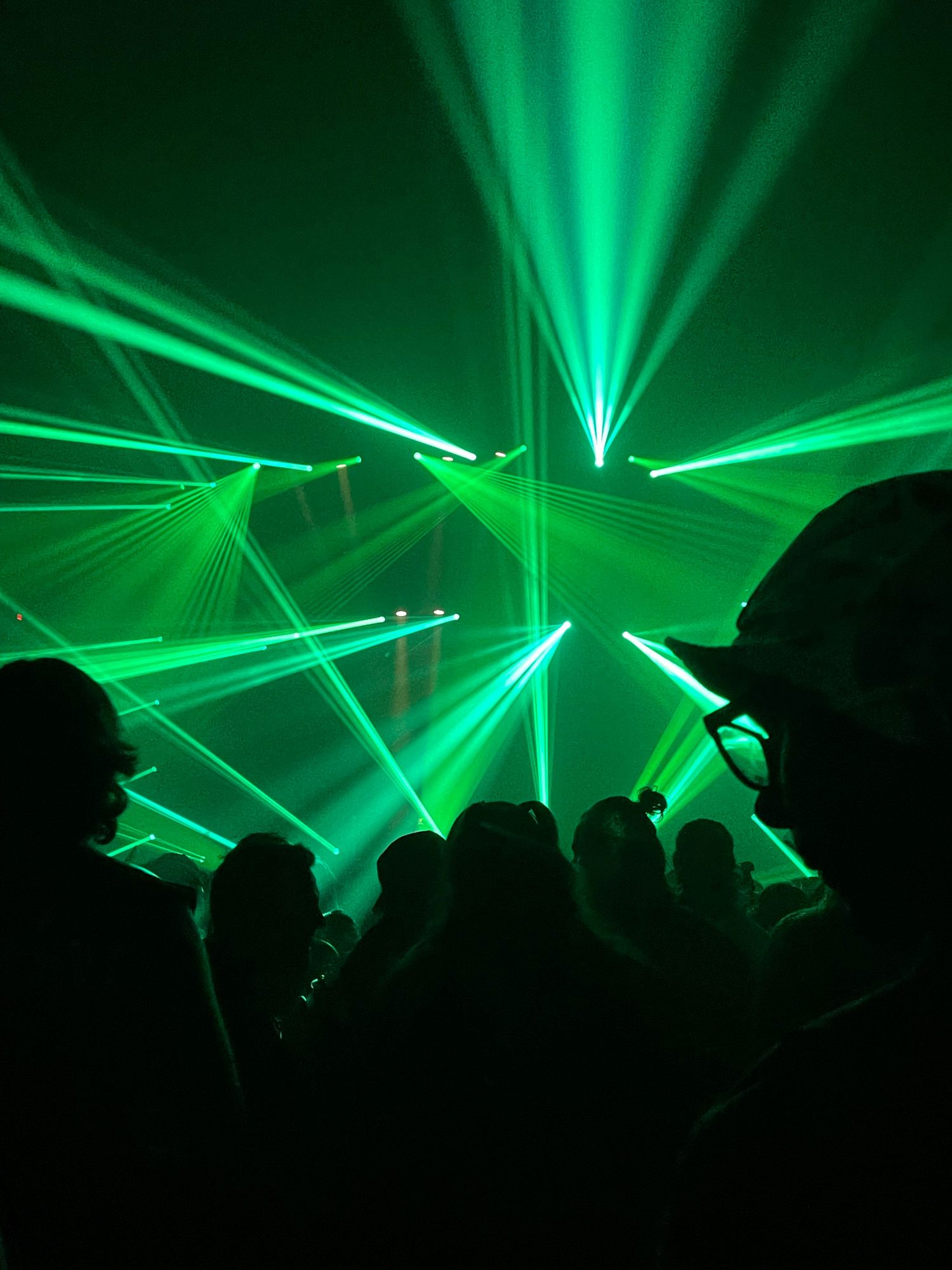 Green lasers over the crowd on the dance floor